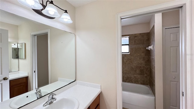 bathroom with vanity and tiled shower / bath combo