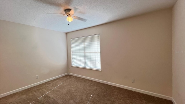 carpeted empty room featuring a textured ceiling and ceiling fan