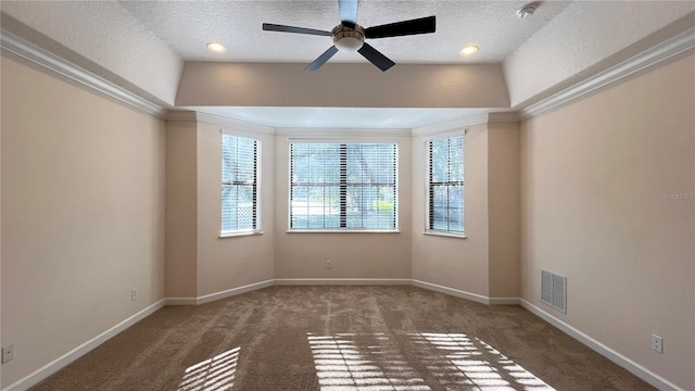 carpeted empty room with lofted ceiling, a textured ceiling, crown molding, and ceiling fan