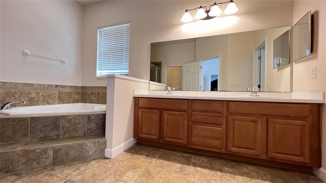 bathroom with tiled bath and vanity