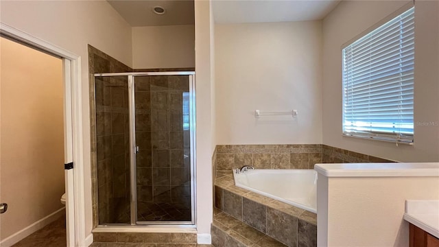 full bathroom with toilet, vanity, and separate shower and tub