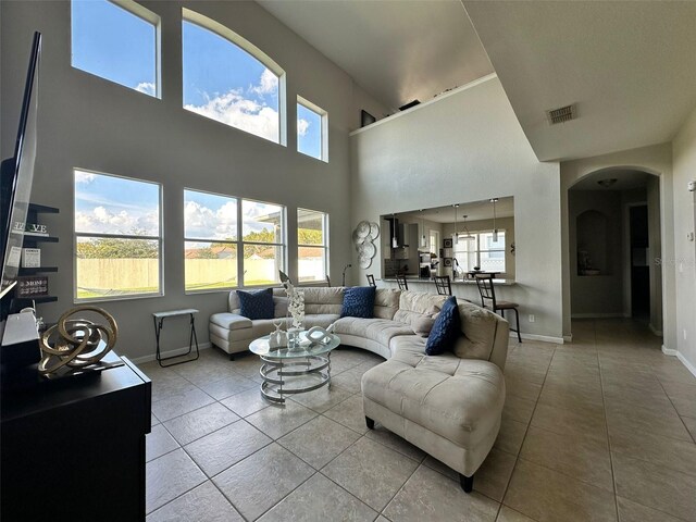 2321 Hinsdale Dr, Kissimmee, FL 34741 - tiled living area with arched walkways and a high ceiling
