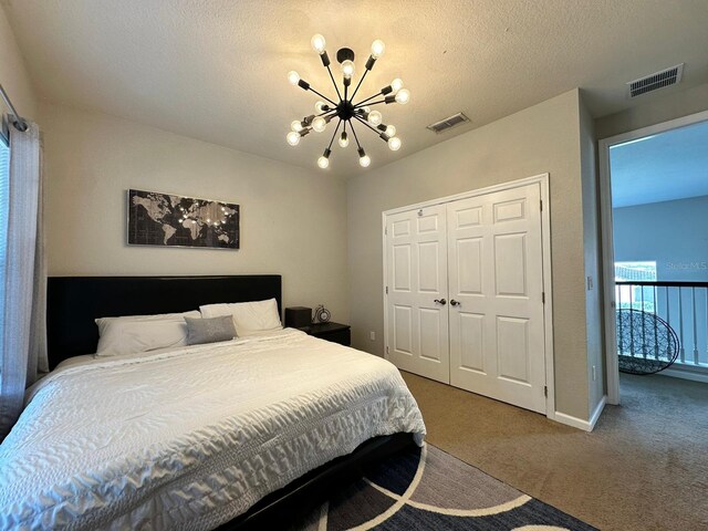 2321 Hinsdale Dr, Kissimmee, FL 34741 - carpeted bedroom featuring a chandelier, a closet, and a textured ceiling