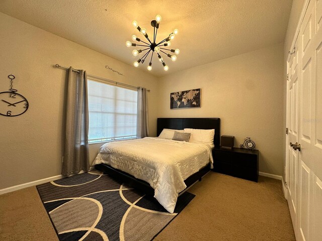 2321 Hinsdale Dr, Kissimmee, FL 34741 - bedroom featuring a chandelier, carpet, a textured ceiling, and a closet