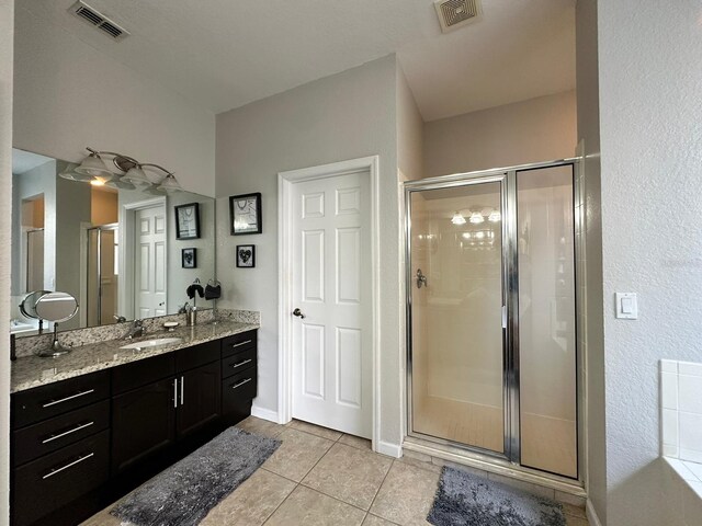 2321 Hinsdale Dr, Kissimmee, FL 34741 - bathroom with a stall shower, vanity, and tile patterned floors