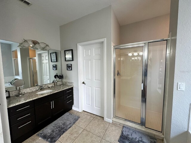 2321 Hinsdale Dr, Kissimmee, FL 34741 - full bathroom with a stall shower, vanity, and tile patterned floors