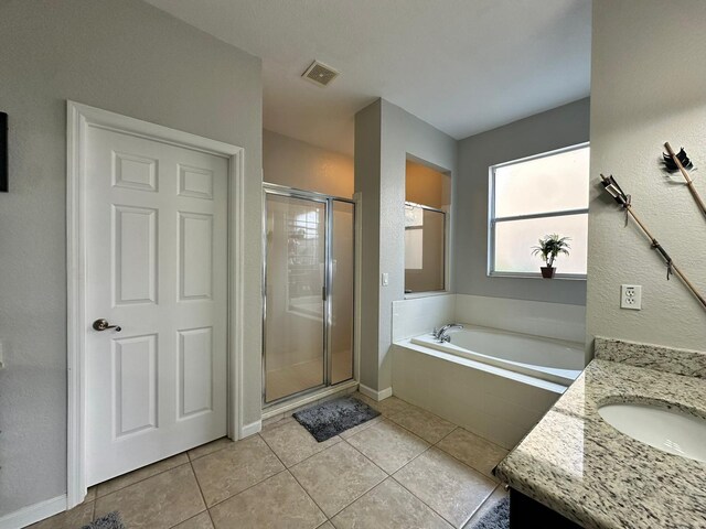 2321 Hinsdale Dr, Kissimmee, FL 34741 - bathroom with a garden tub, a shower stall, vanity, and tile patterned flooring