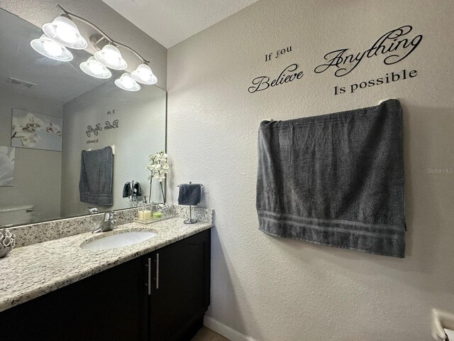2321 Hinsdale Dr, Kissimmee, FL 34741 - bathroom with vanity and a textured wall