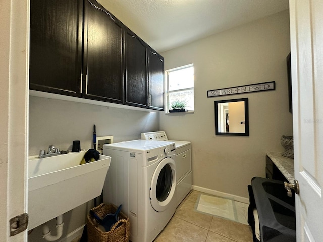 2321 Hinsdale Dr, Kissimmee, FL 34741 - laundry area with cabinet space, washer and dryer, and light tile patterned floors