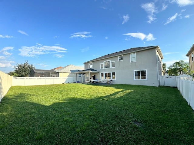 back of property featuring a lawn