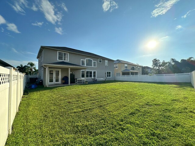 2321 Hinsdale Dr, Kissimmee, FL 34741 - rear view of property with french doors, a fenced backyard, and stucco siding