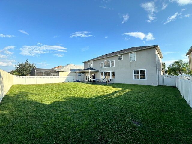 2321 Hinsdale Dr, Kissimmee, FL 34741 - rear view of property with a fenced backyard