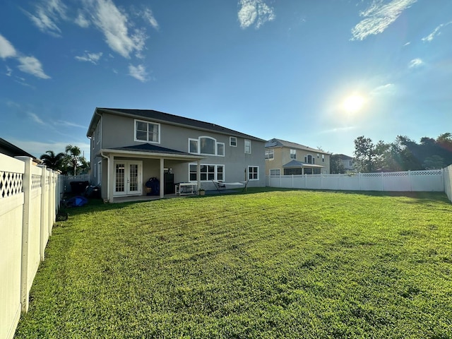 2321 Hinsdale Dr, Kissimmee, FL 34741 - back of property featuring french doors, a fenced backyard, and stucco siding