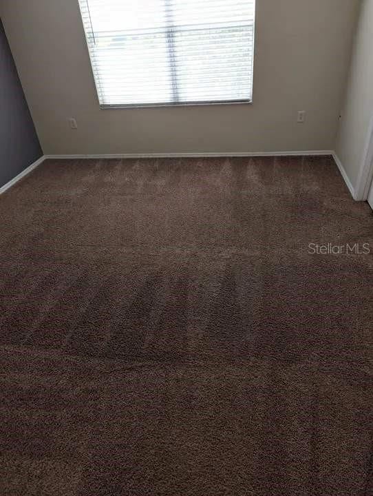 empty room with dark carpet