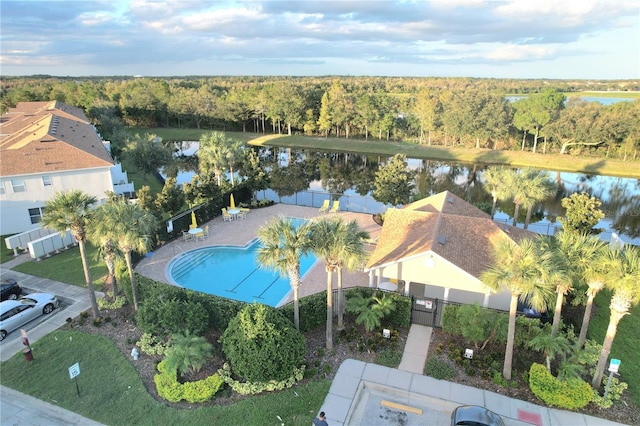 birds eye view of property with a water view and a view of trees