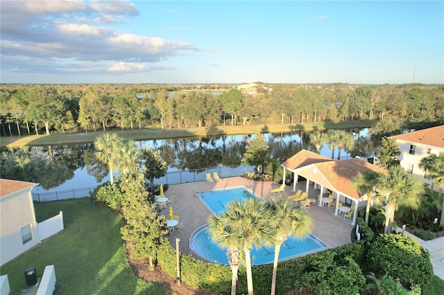 birds eye view of property with a water view and a wooded view