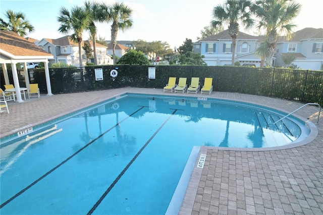 pool with fence and a residential view
