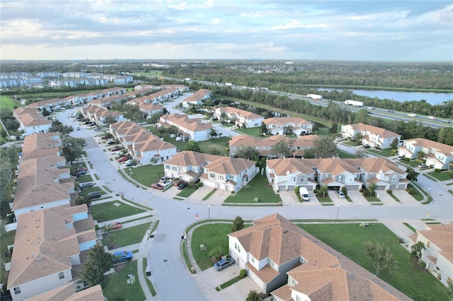 bird's eye view featuring a water view and a residential view