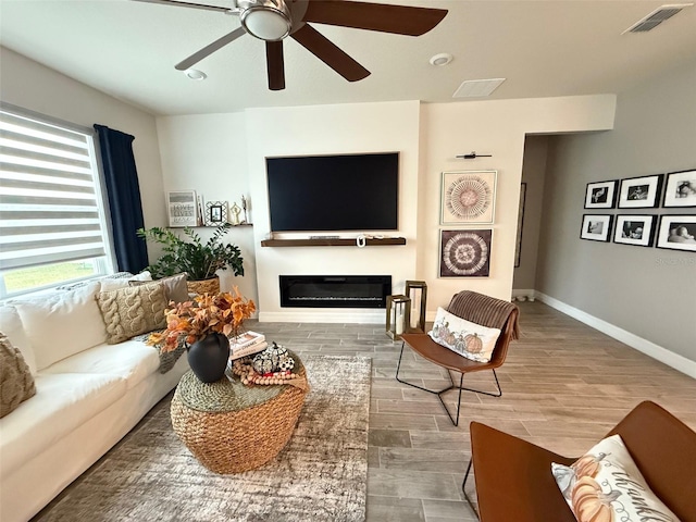 living room with hardwood / wood-style flooring and ceiling fan