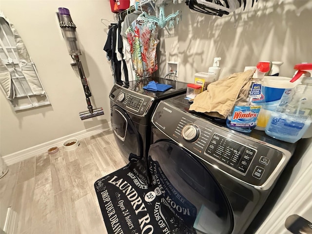 laundry room with hardwood / wood-style floors and independent washer and dryer