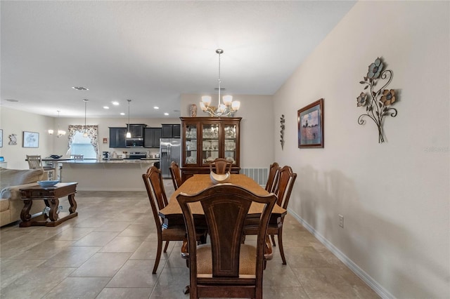 tiled dining area with a chandelier