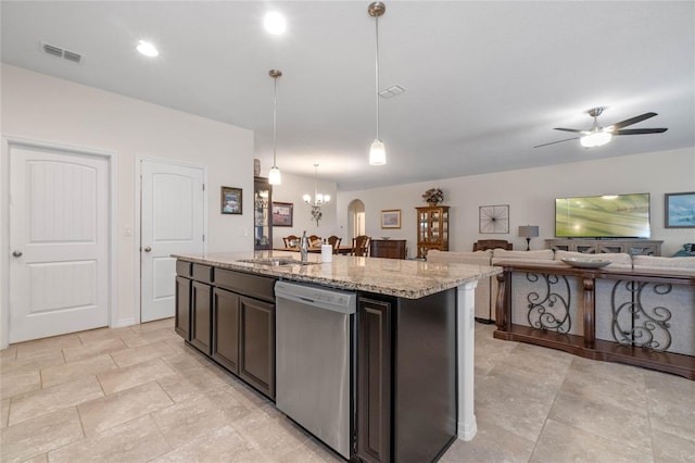 kitchen featuring hanging light fixtures, sink, a center island with sink, dishwasher, and light stone countertops