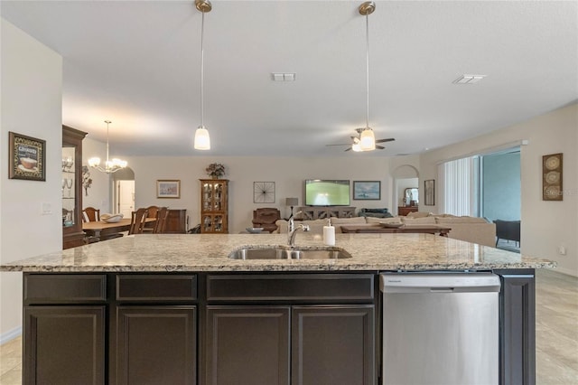 kitchen with decorative light fixtures, a kitchen island with sink, sink, and stainless steel dishwasher