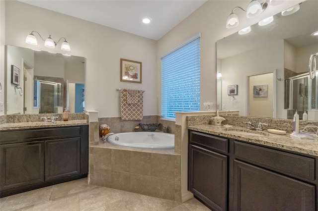 bathroom featuring tile patterned flooring, vanity, and shower with separate bathtub