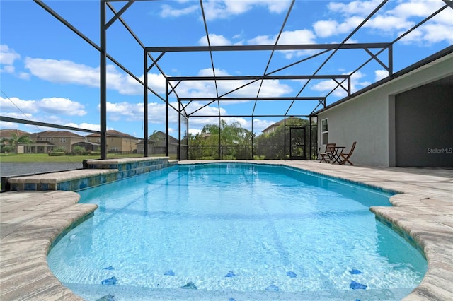 view of pool with a lanai and a patio area