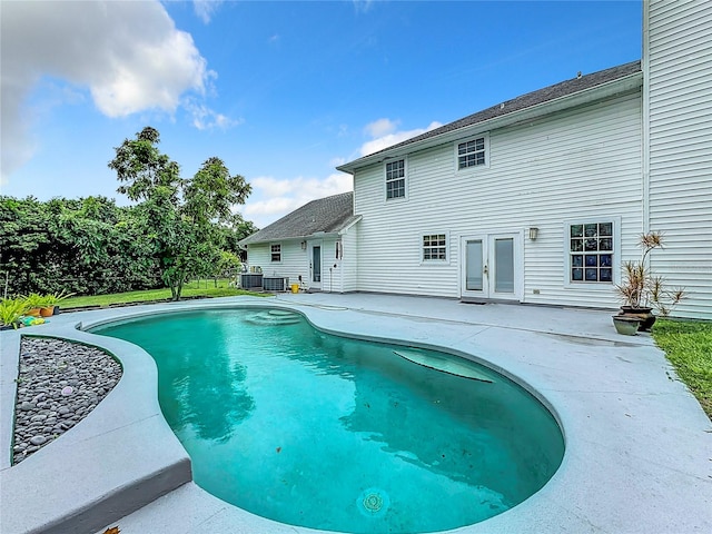 view of swimming pool with a patio area and central AC unit