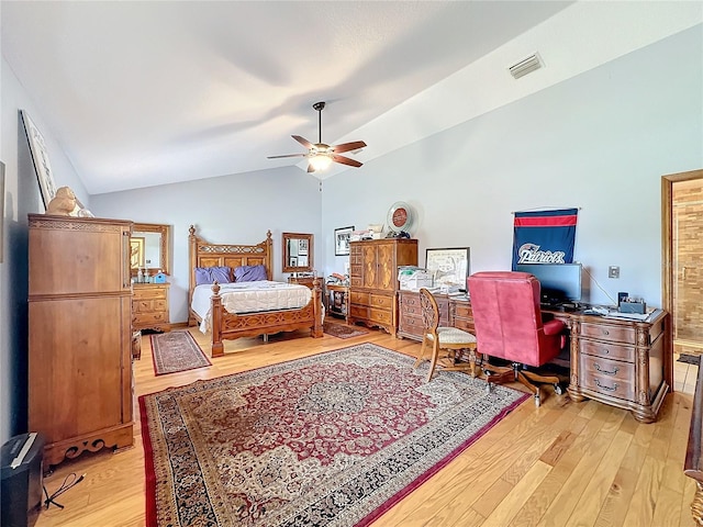 bedroom featuring ceiling fan, light wood-type flooring, and vaulted ceiling