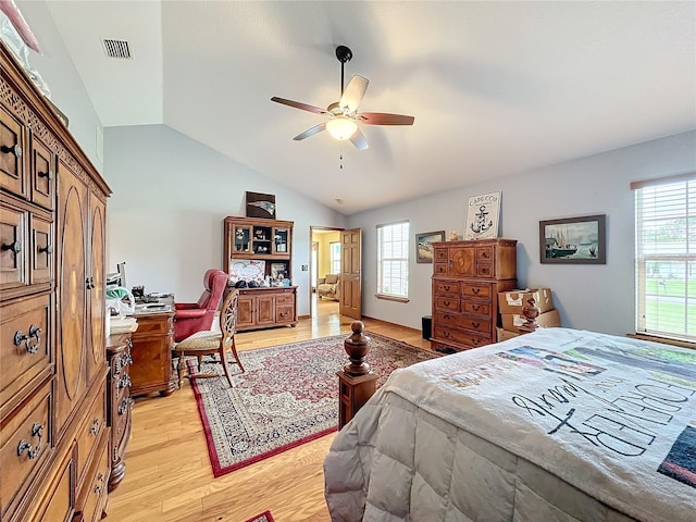 bedroom featuring lofted ceiling, light hardwood / wood-style flooring, multiple windows, and ceiling fan