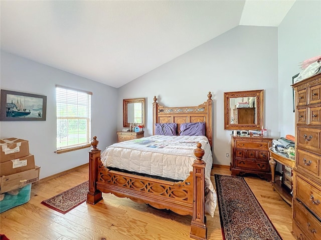 bedroom featuring lofted ceiling and light hardwood / wood-style floors