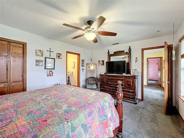 carpeted bedroom featuring ceiling fan, a closet, and a textured ceiling