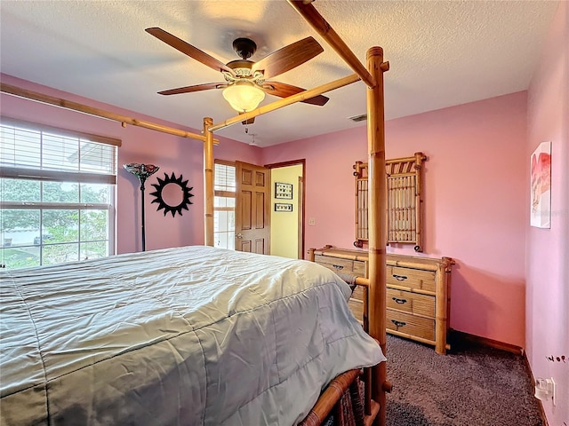 bedroom with dark carpet, a textured ceiling, and ceiling fan