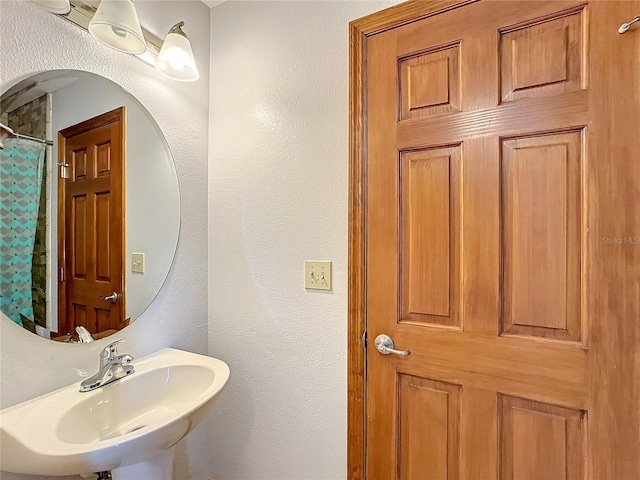 bathroom with sink and a shower with curtain