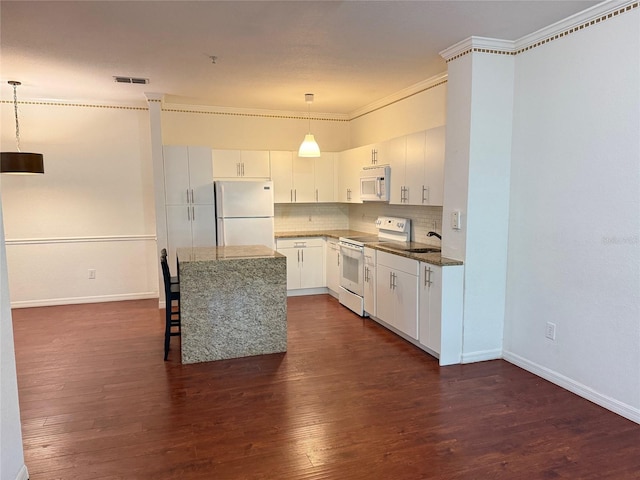 kitchen featuring dark wood-type flooring, white appliances, hanging light fixtures, white cabinetry, and ornamental molding