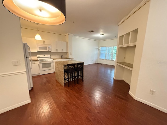 kitchen with pendant lighting, dark wood-type flooring, white appliances, and white cabinetry