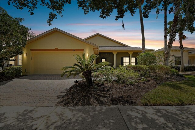 196 Ventana Dr, Kissimmee, FL 34759 - ranch-style home with a garage, stucco siding, and decorative driveway
