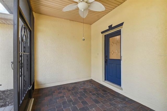 doorway to property featuring ceiling fan