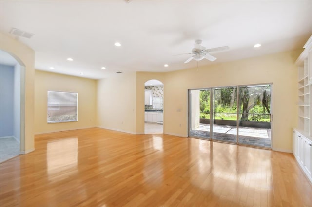 unfurnished living room featuring ceiling fan and light hardwood / wood-style flooring