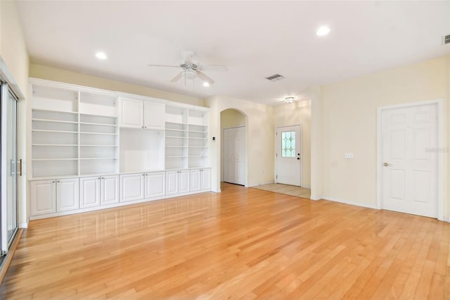 unfurnished living room featuring light hardwood / wood-style flooring and ceiling fan