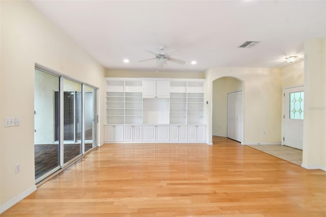 unfurnished living room featuring light wood-type flooring and ceiling fan