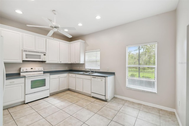 kitchen featuring white appliances, light tile patterned flooring, sink, white cabinetry, and ceiling fan