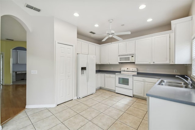 kitchen with white cabinets, ceiling fan, light tile patterned flooring, sink, and white appliances