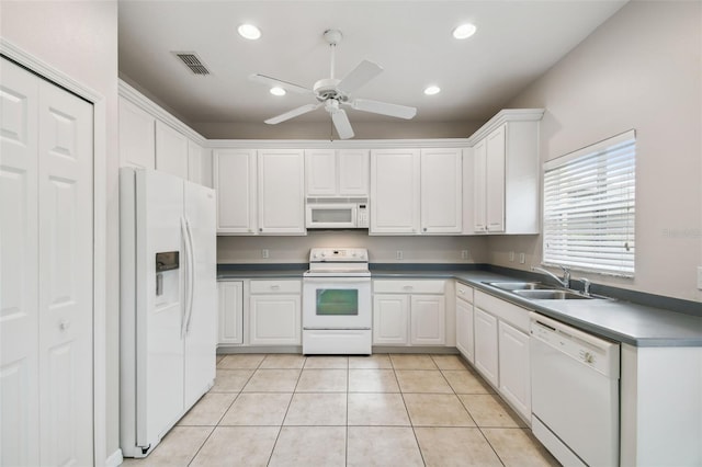 kitchen with sink, white cabinets, white appliances, and light tile patterned floors