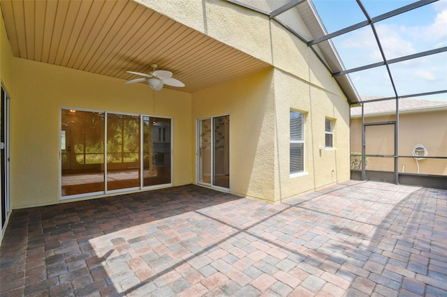 view of patio featuring ceiling fan and a lanai