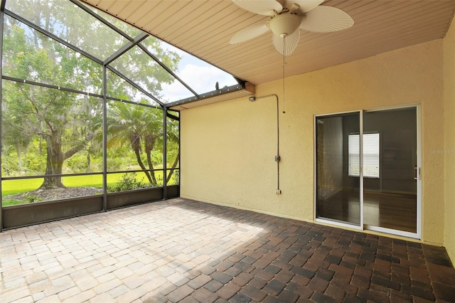 unfurnished sunroom with ceiling fan and wooden ceiling