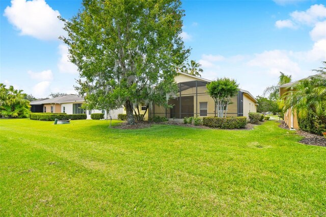 196 Ventana Dr, Kissimmee, FL 34759 - view of green lawn featuring glass enclosure