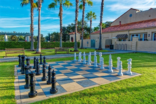 view of property's community with a yard, a patio area, and a pergola